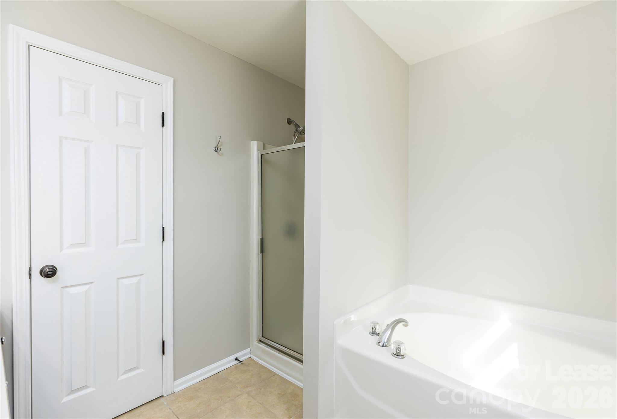 9724 Steele Meadow Road Charlotte, NC 28273 - Photo 29 of 38 a white bath tub sitting in a bathroom