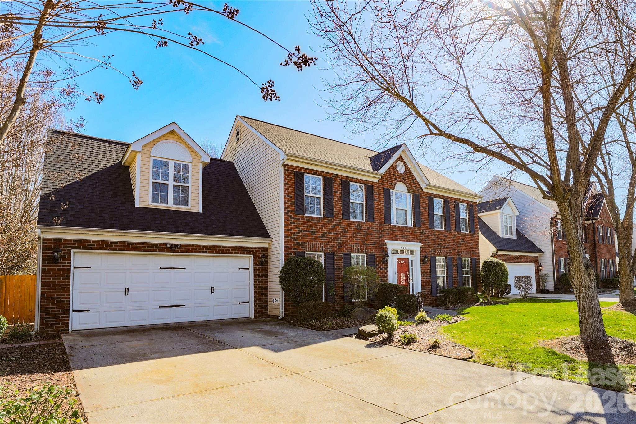 9724 Steele Meadow Road Charlotte, NC 28273 - Photo 4 of 38 a front view of a house with a yard and garage