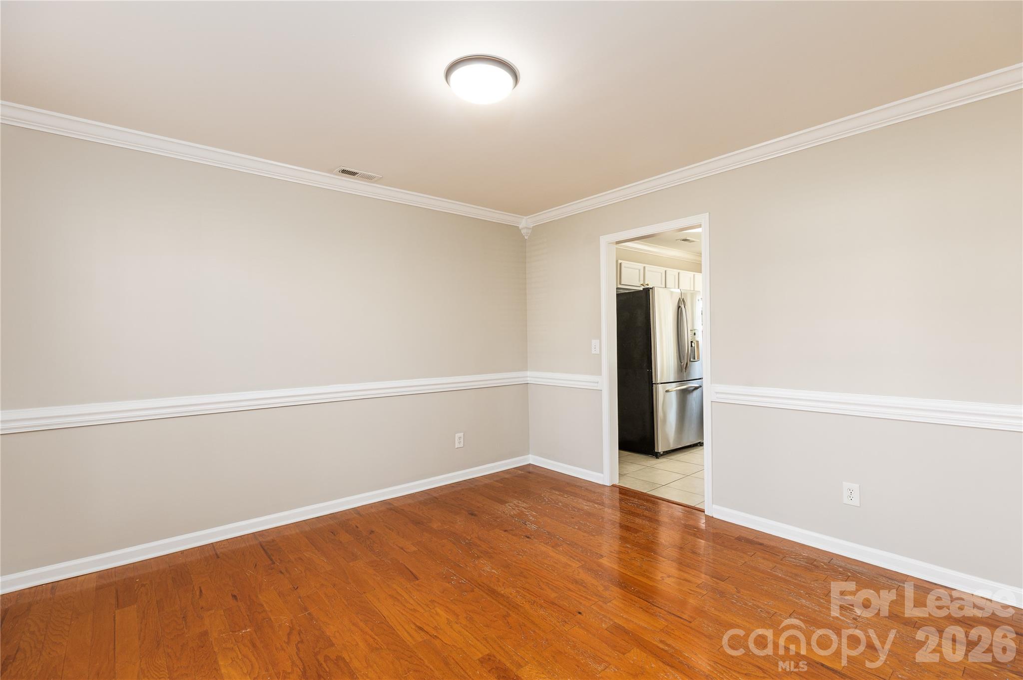 9724 Steele Meadow Road Charlotte, NC 28273 - Photo 9 of 38 an empty room with wooden floor and windows