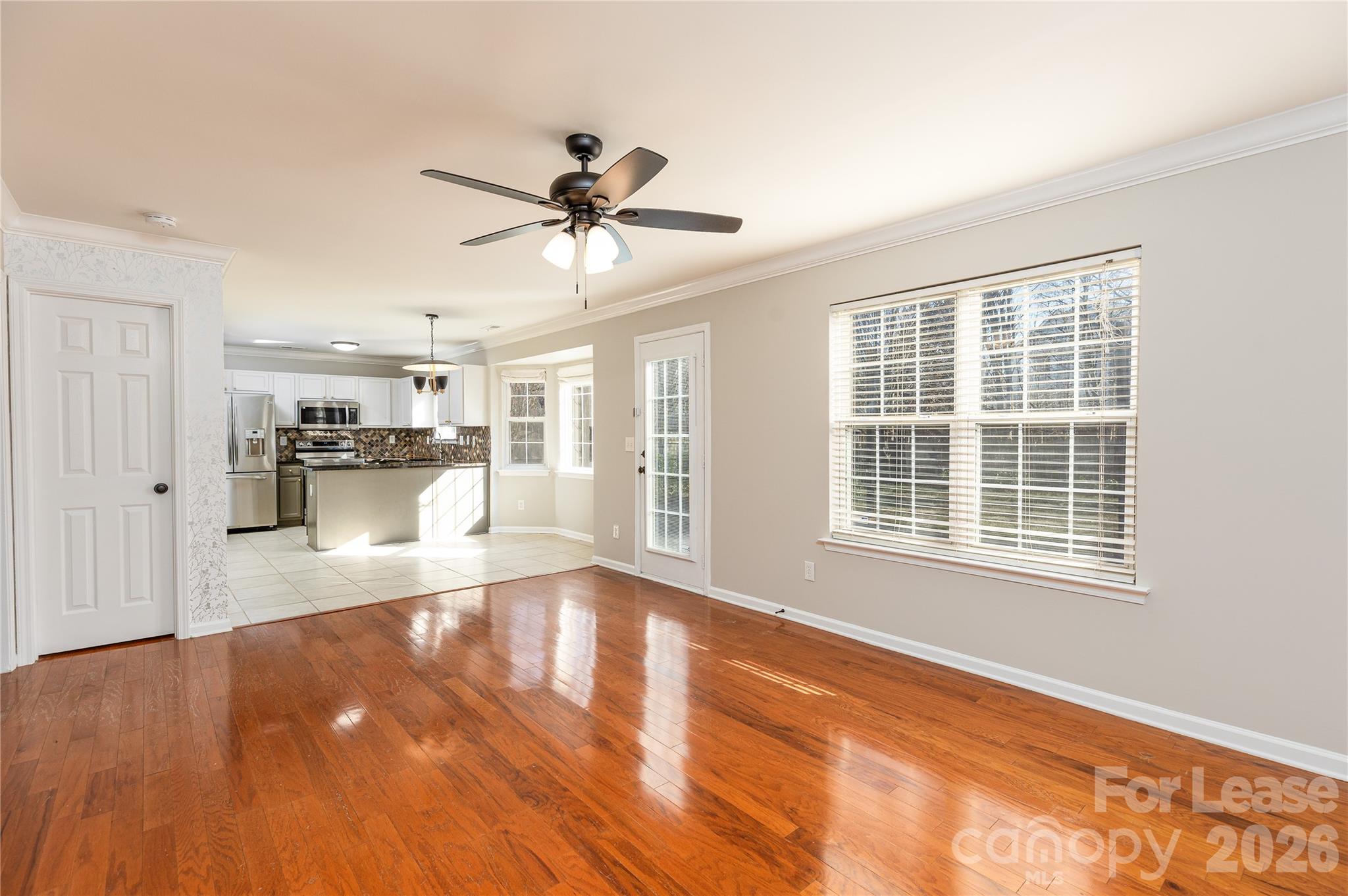 9724 Steele Meadow Road Charlotte, NC 28273 - Photo 10 of 38 a view of empty room with wooden floor and a window