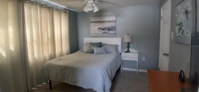 a bedroom with a bed and a chandelier