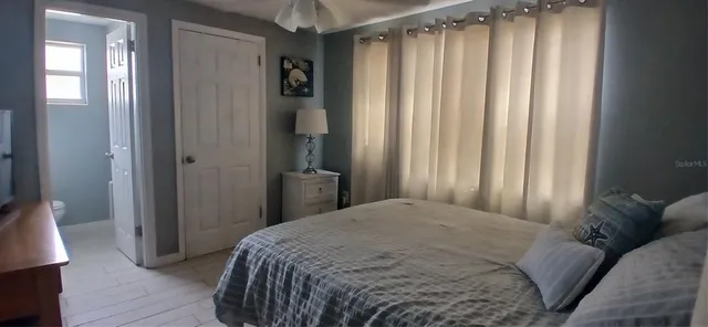 a bedroom with a bed and a mirror