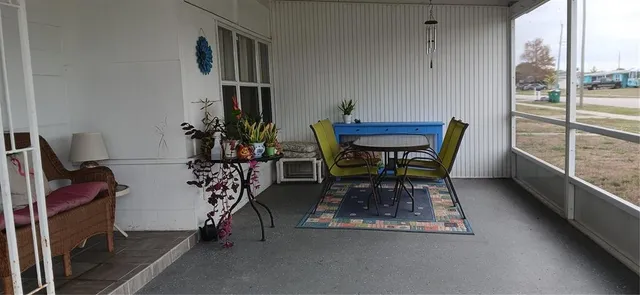 a dining room with furniture and a window
