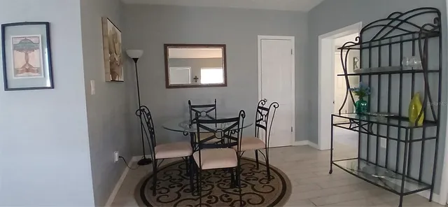 a dining room with furniture and wooden floor