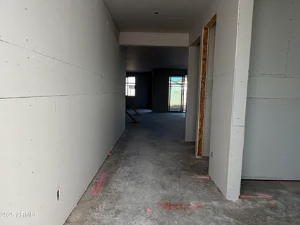 a view of a hallway with wooden floor and closet