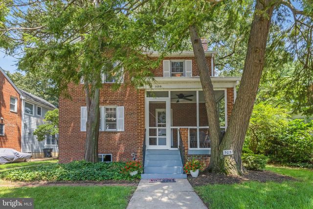 a front view of a house with yard and green space