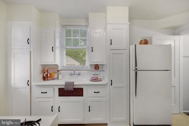 a white refrigerator freezer sitting inside of a kitchen