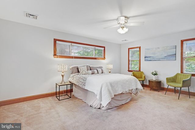 a spacious bedroom with a bed and a chandelier