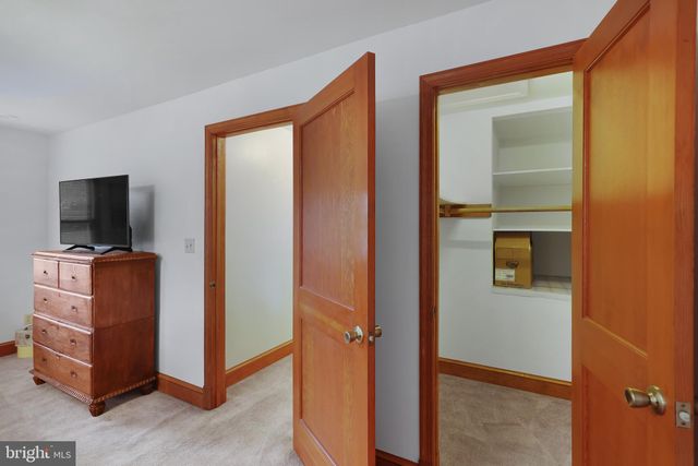 a room that has a bed and mirror in it