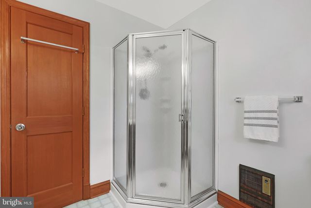 a bathroom with a glass shower door