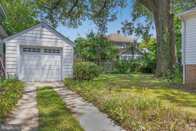 a view of house with backyard and garden