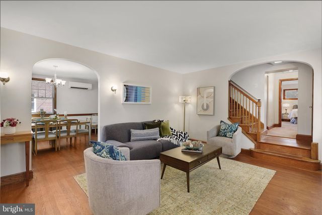 a living room with furniture a rug and a window