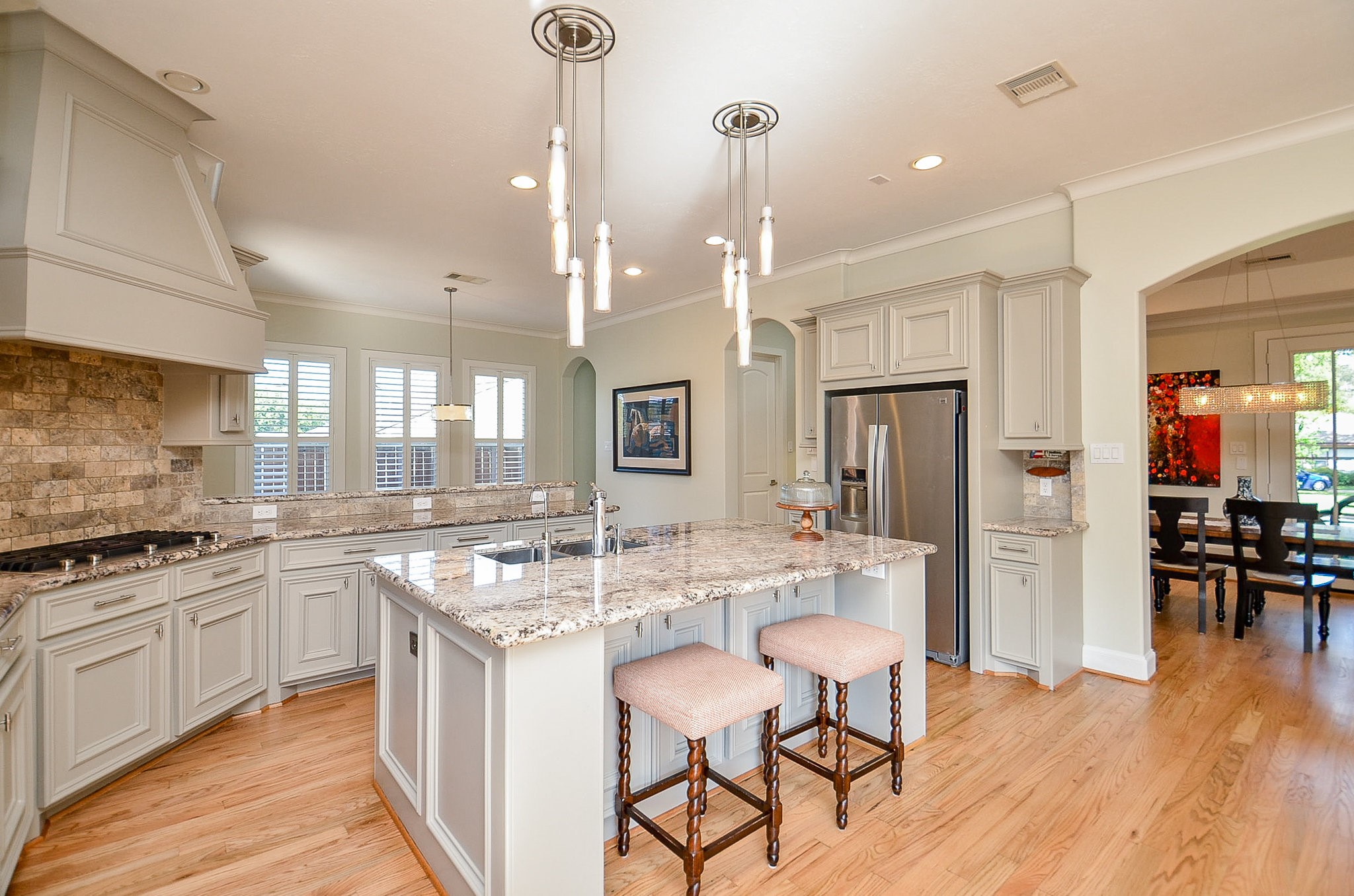 4625 Maple Street Bellaire, TX 77401 - Photo 17 of 47 a kitchen with stainless steel appliances granite countertop a stove and refrigerator a oven with wooden floors