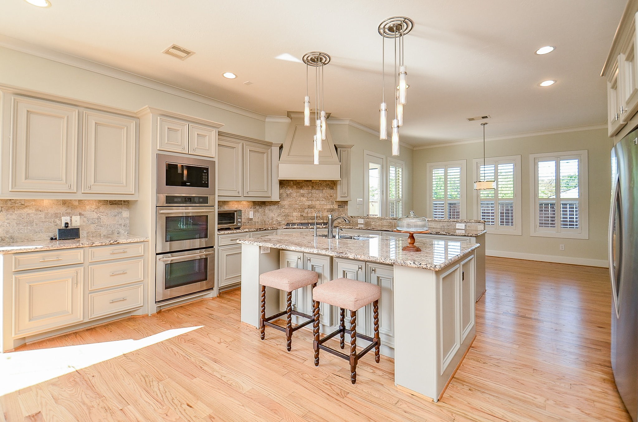 4625 Maple Street Bellaire, TX 77401 - Photo 19 of 47 a kitchen with kitchen island granite countertop a sink cabinets and stainless steel appliances