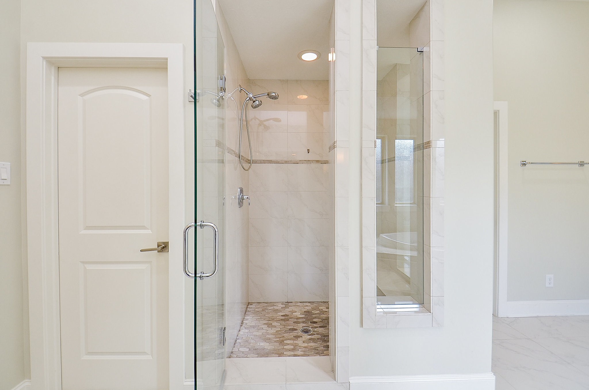 4625 Maple Street Bellaire, TX 77401 - Photo 33 of 47 a bathroom with a glass shower door