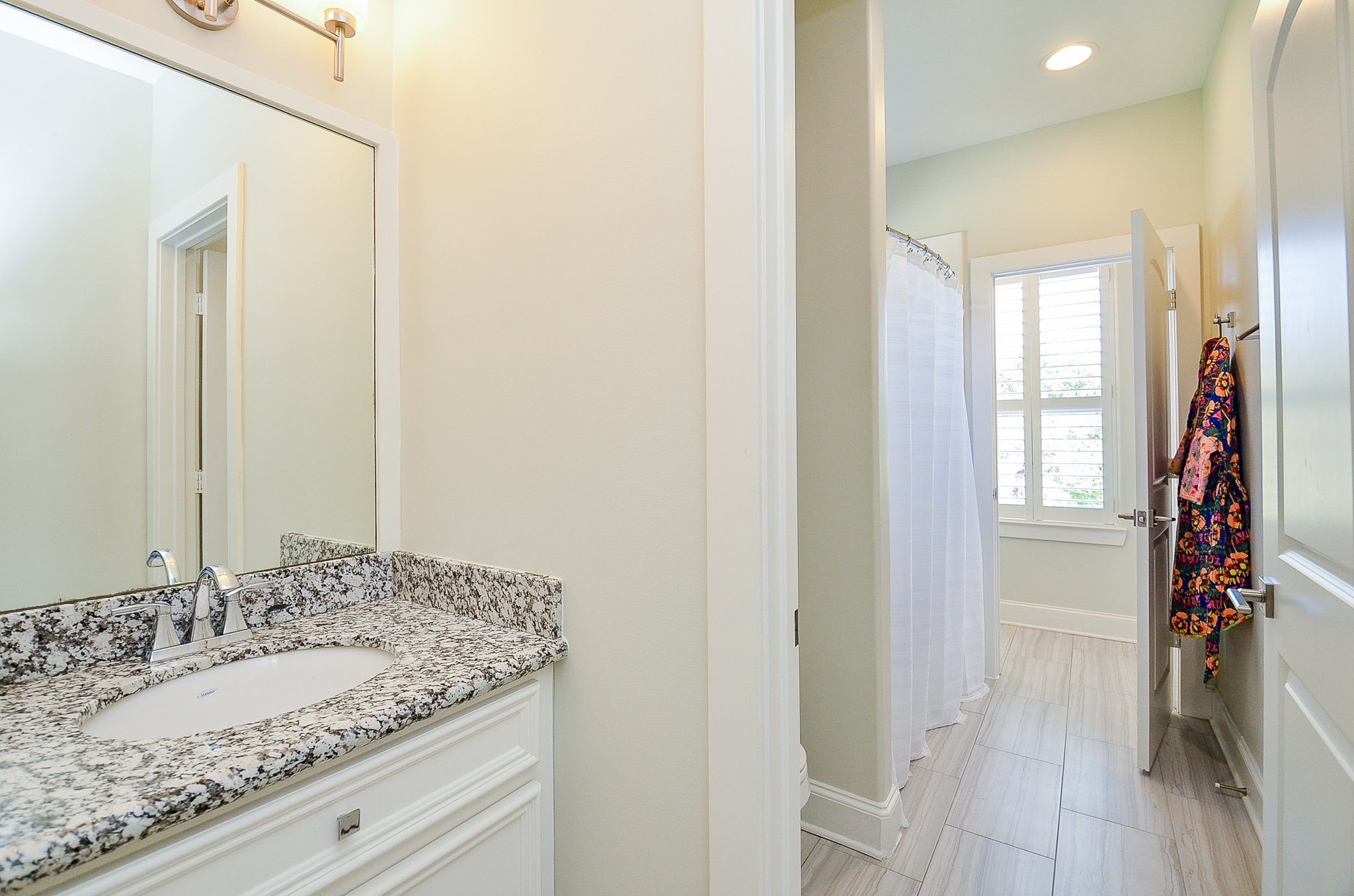 4625 Maple Street Bellaire, TX 77401 - Photo 40 of 47 a bathroom with a granite countertop sink and a mirror