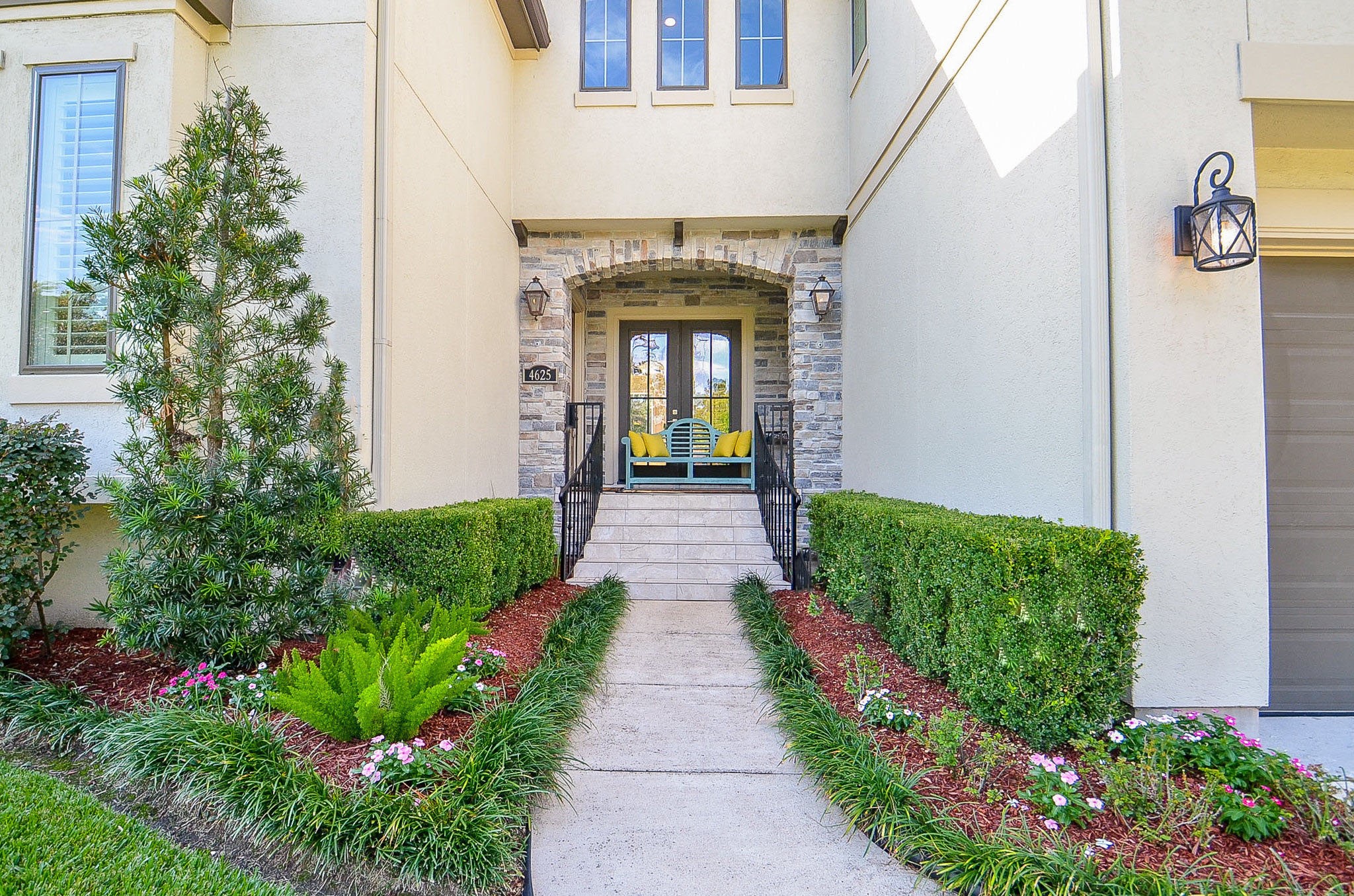 4625 Maple Street Bellaire, TX 77401 - Photo 4 of 47 a front view of a house with a garden