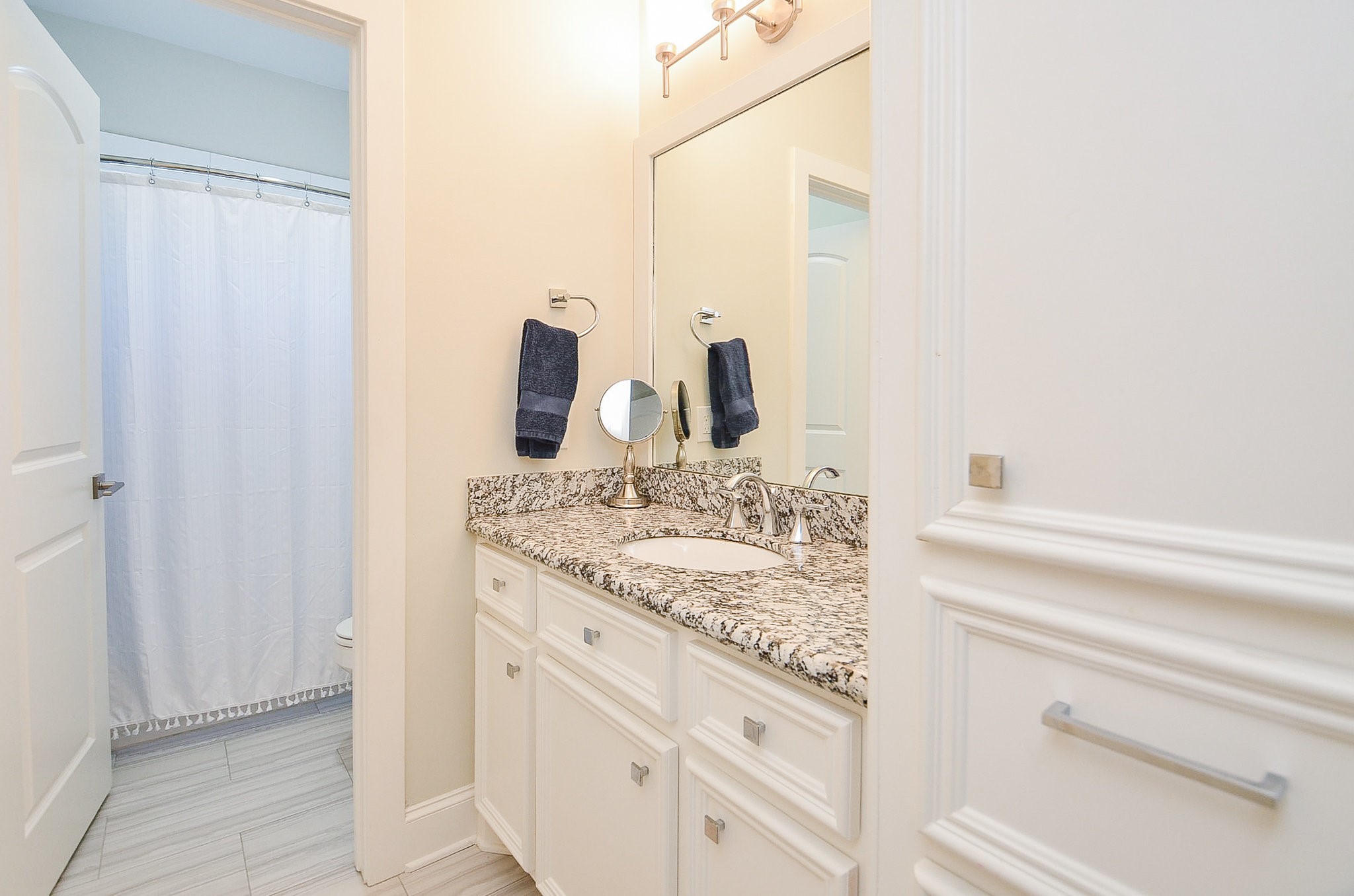 4625 Maple Street Bellaire, TX 77401 - Photo 41 of 47 a bathroom with a granite countertop sink and a mirror