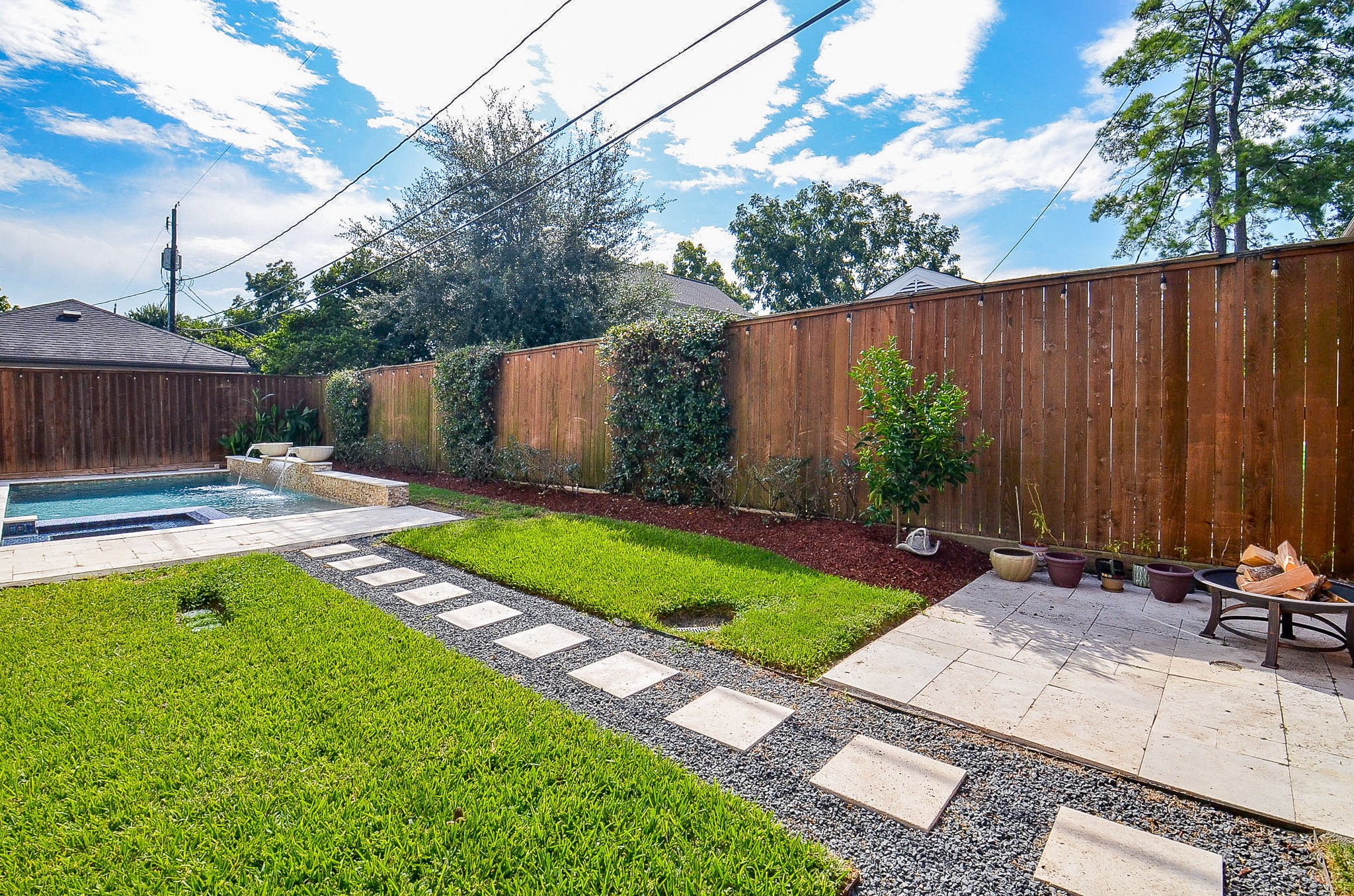 4625 Maple Street Bellaire, TX 77401 - Photo 46 of 47 a view of a backyard with a table and chairs with wooden fence