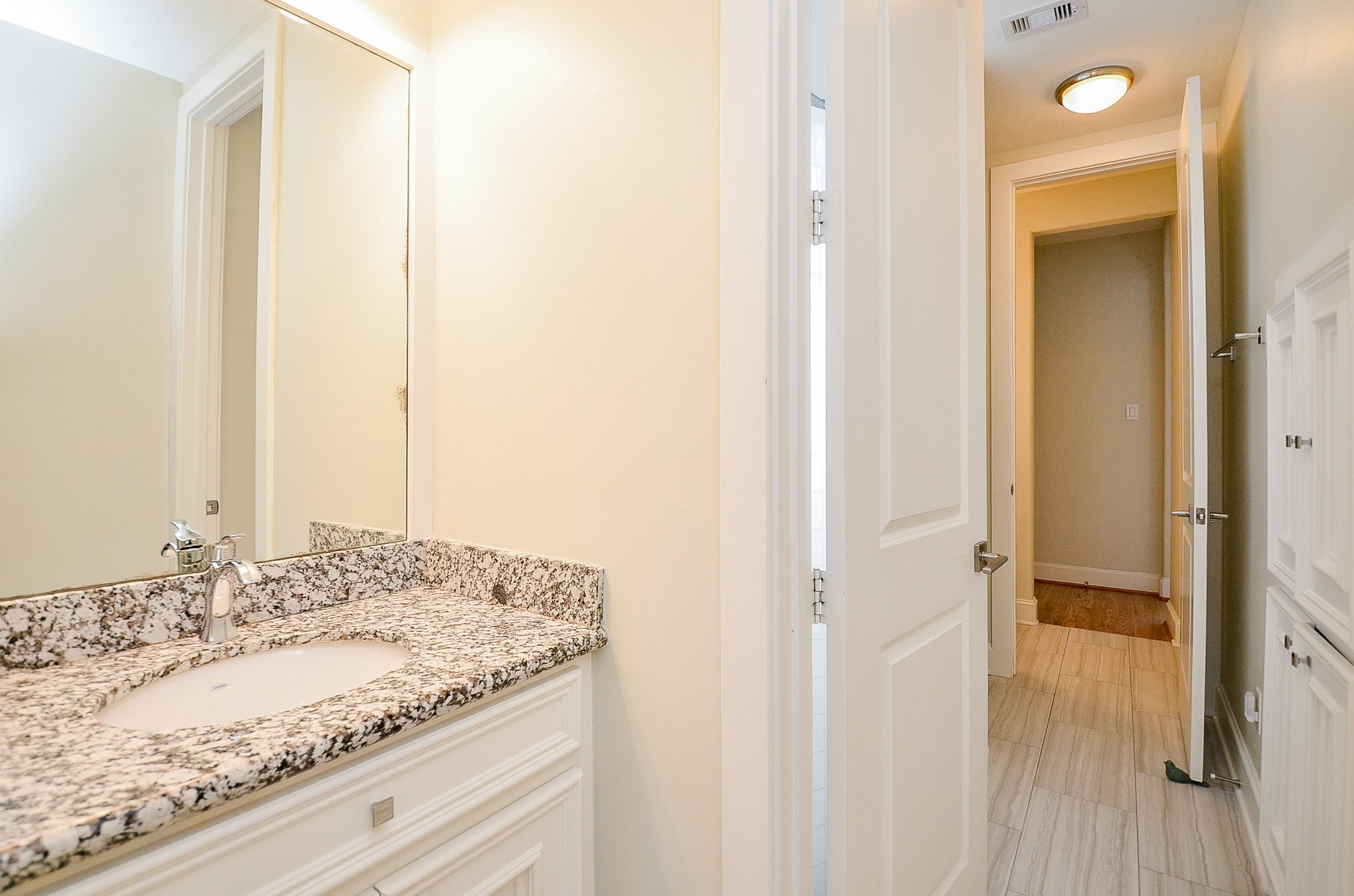 4625 Maple Street Bellaire, TX 77401 - Photo 9 of 47 a bathroom with a granite countertop sink and a mirror