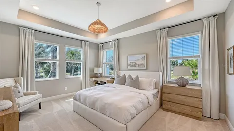 a bedroom with a large bed and a chandelier