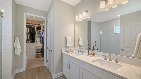 a bathroom with a sink double vanity and a mirror