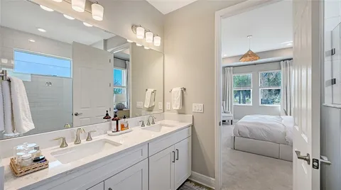 a en suite bathroom with a double vanity sink mirror and