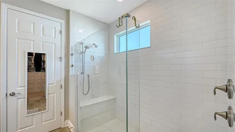 a view of walk in closet with clothes