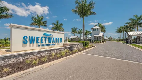 a view of a house with a swimming pool and sitting area