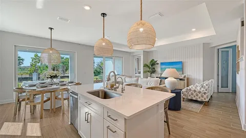 a kitchen with stainless steel appliances granite countertop a stove and a wooden floors
