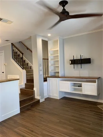 a view of entryway and kitchen with wooden floor