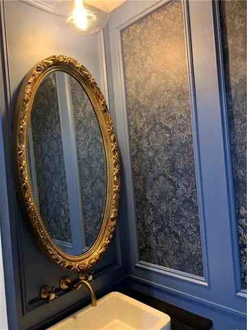 a bathroom with a toilet mirror and vanity