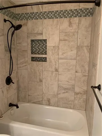 a bathroom with a shower and a shower