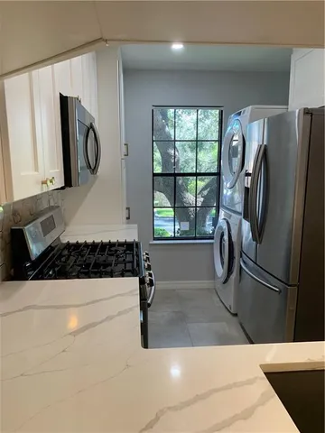 a kitchen with a refrigerator and a sink