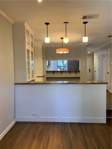 a kitchen with kitchen island granite countertop wooden cabinets and a stainless steel appliances