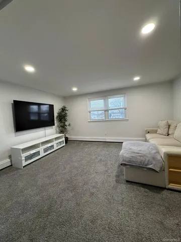 a spacious bedroom with a bed and a flat screen tv