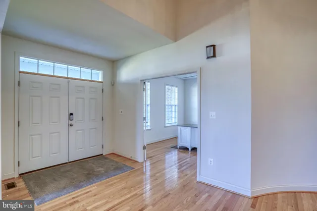 a view of a livingroom with wooden floor and a fireplace
