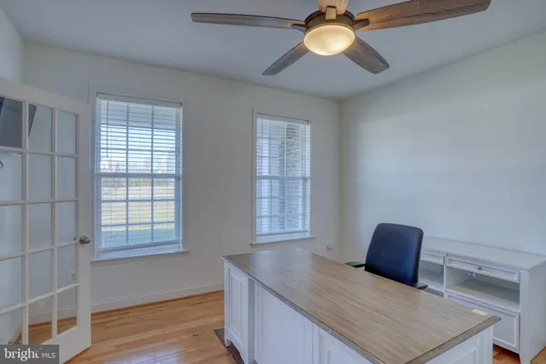 a large kitchen with kitchen island a sink a stove a counter space and cabinets