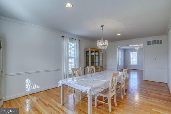 a kitchen with stainless steel appliances granite countertop a sink a stove and a wooden floors