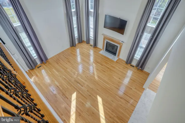 a kitchen with stainless steel appliances granite countertop a sink a stove and a wooden floors