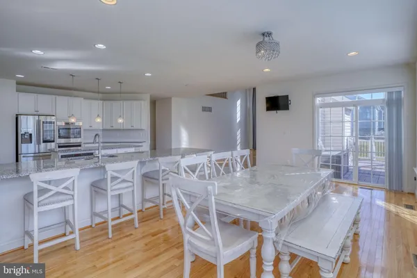 a kitchen with stainless steel appliances granite countertop a sink a stove and a refrigerator