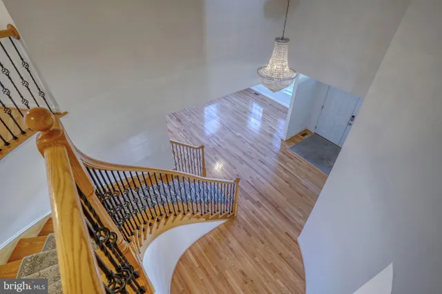 a view of a room with wooden furniture and a large window