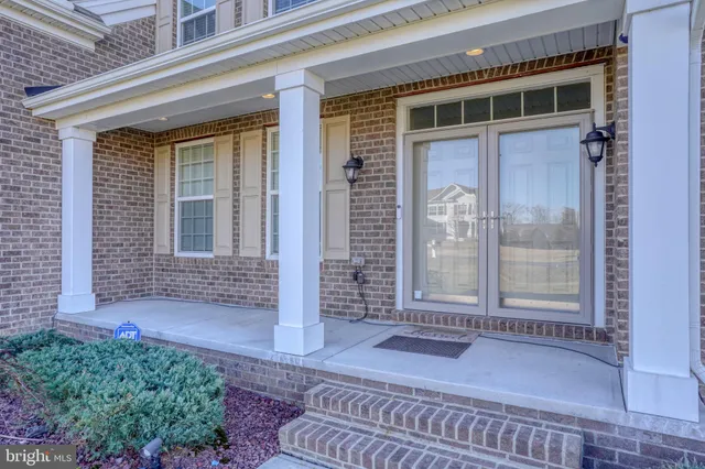 a view of a house with a big yard and large trees