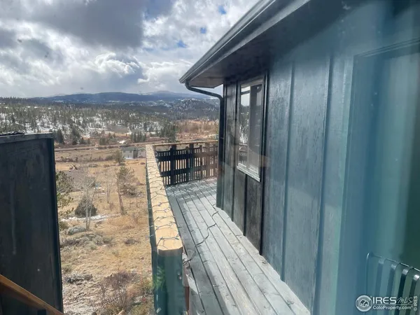 a view of a balcony with wooden floor and city view