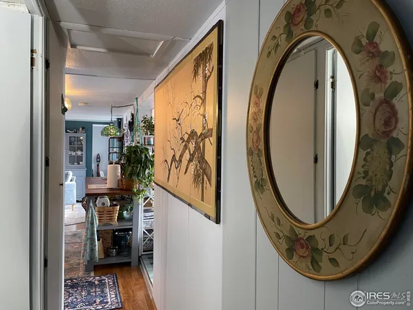 a bedroom with a bed and a flat tv screen on dresser