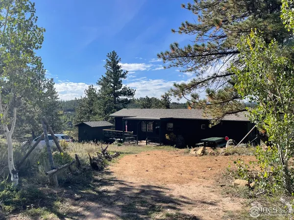 a view of a house with a yard covered in snow