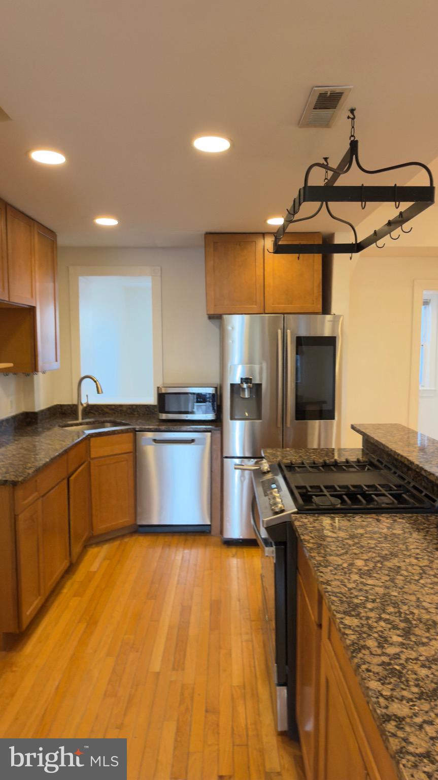 1117 7th Street Northeast Washington, DC 20002 - Photo 4 of 11 a kitchen with granite countertop a stove and a sink