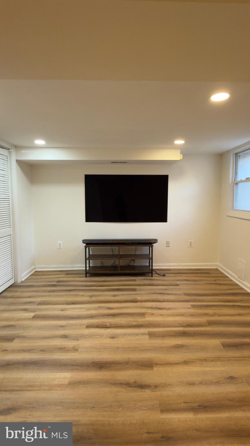 1117 7th Street Northeast Washington, DC 20002 - Photo 5 of 11 a view of room with wooden floor and flat screen tv