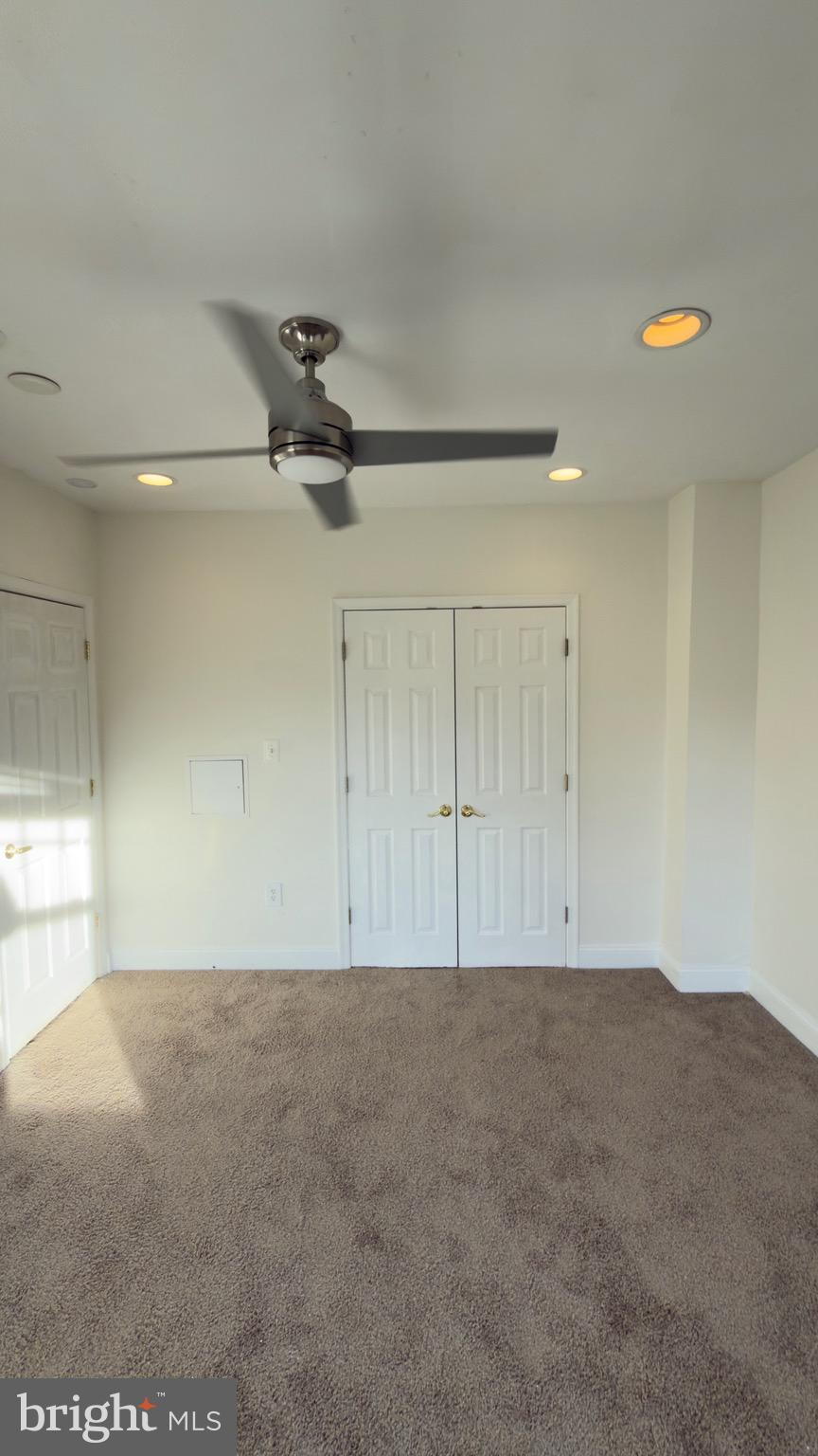 1117 7th Street Northeast Washington, DC 20002 - Photo 9 of 11 an empty room with a ceiling fan and window