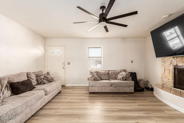 a kitchen with stainless steel appliances kitchen island hardwood floor and a sink